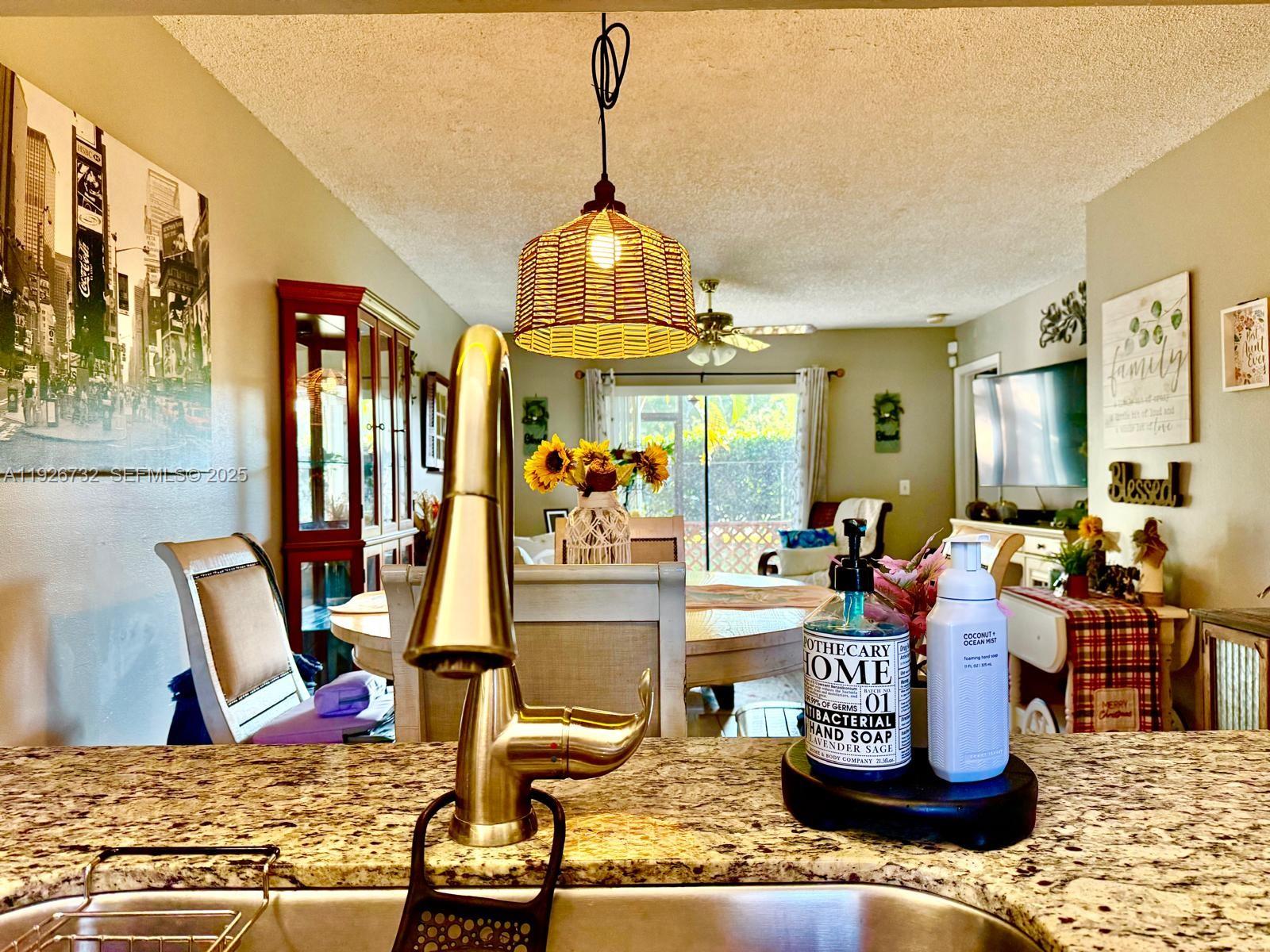 10616 Northwest 10th Street, Unit 104 Pembroke Pines, FL 33026 - Photo 19 of 47 a living room with fireplace furniture and a chandelier