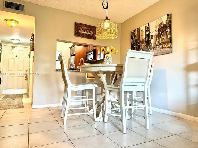 a view of a dining room with furniture and a chandelier