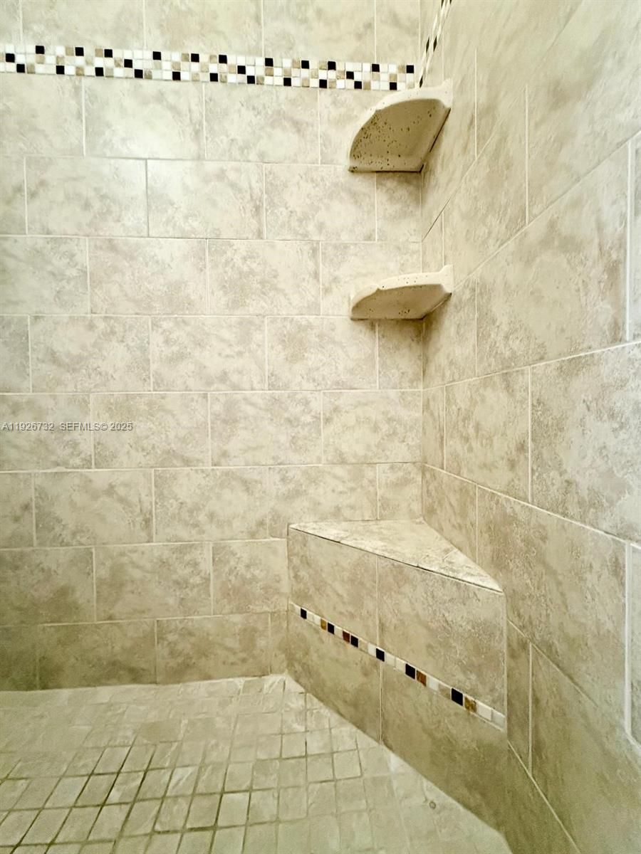 10616 Northwest 10th Street, Unit 104 Pembroke Pines, FL 33026 - Photo 27 of 47 a bathroom with a bathtub