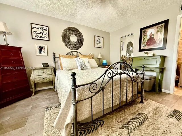 a bedroom with furniture and a mirror