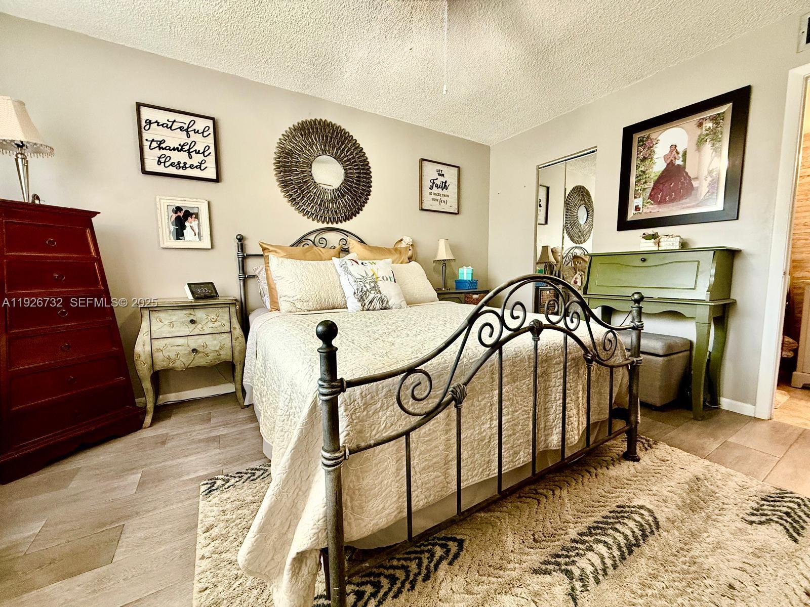 10616 Northwest 10th Street, Unit 104 Pembroke Pines, FL 33026 - Photo 3 of 47 a bedroom with furniture and a mirror