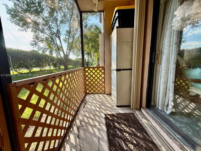 a view of a balcony with wooden floor