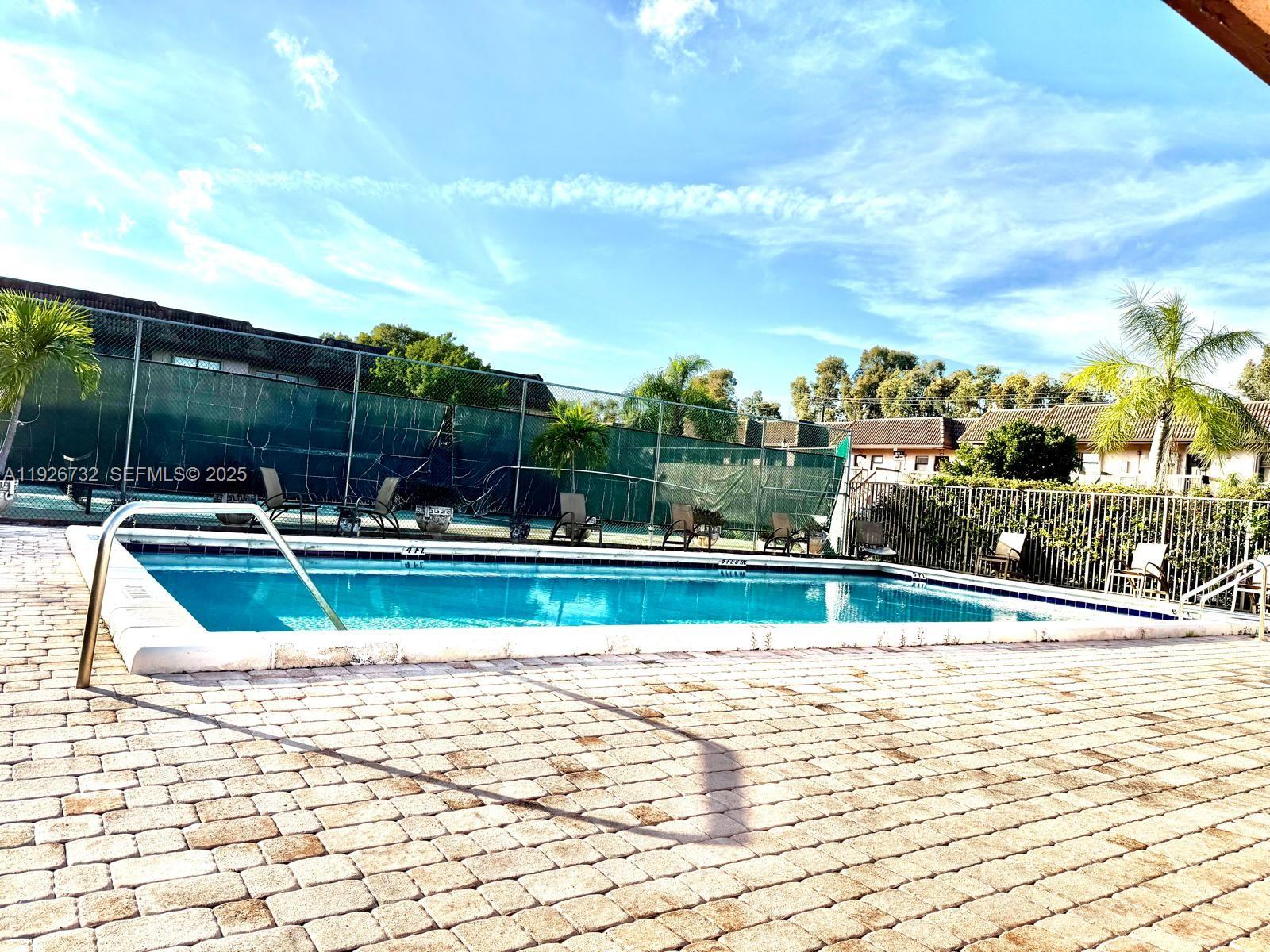 10616 Northwest 10th Street, Unit 104 Pembroke Pines, FL 33026 - Photo 37 of 47 a view of swimming pool with a yard and plants