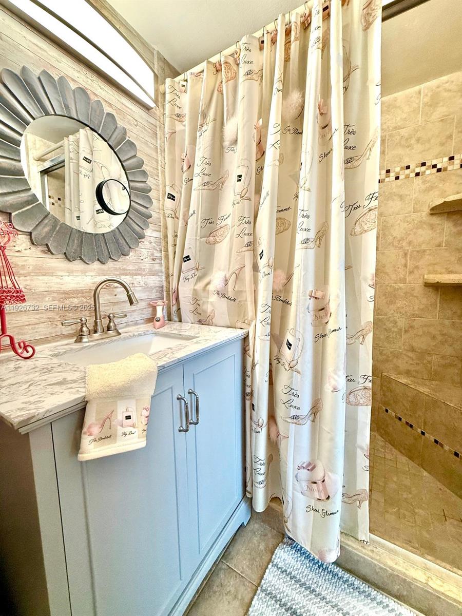 10616 Northwest 10th Street, Unit 104 Pembroke Pines, FL 33026 - Photo 4 of 47 a bathroom with a sink and a mirror