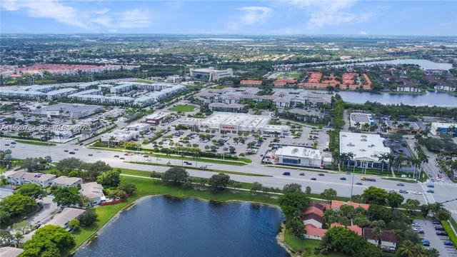 an aerial view of lake and residential houses with outdoor space