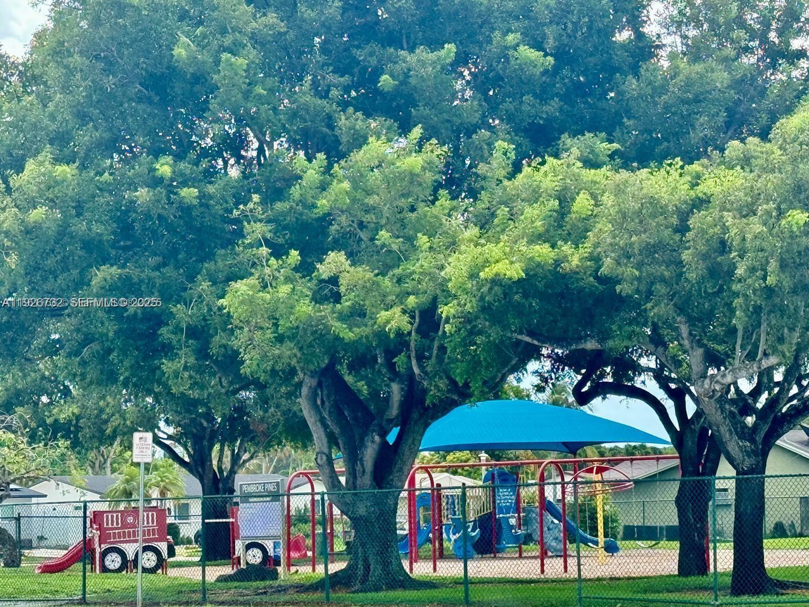 10616 Northwest 10th Street, Unit 104 Pembroke Pines, FL 33026 - Photo 44 of 47 a view of yard with green space and seating area