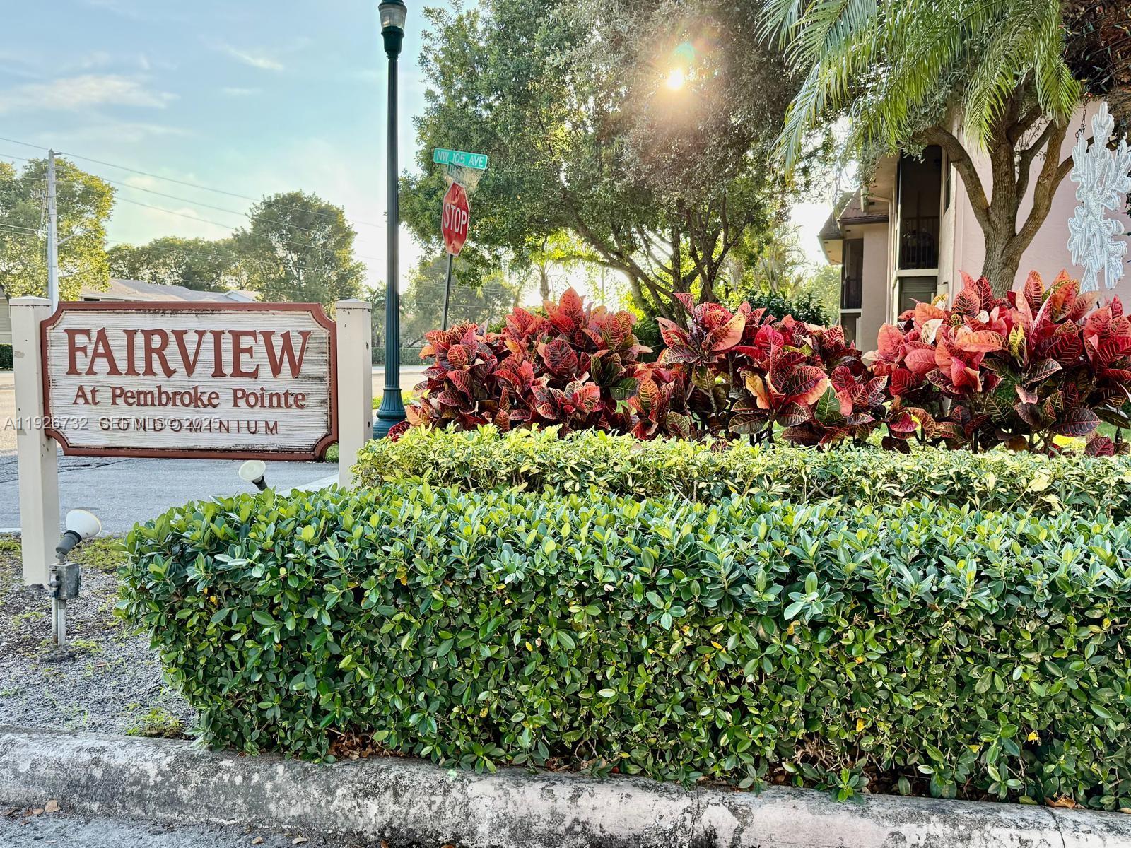 10616 Northwest 10th Street, Unit 104 Pembroke Pines, FL 33026 - Photo 5 of 47 a view of a sign board with buildings in the background