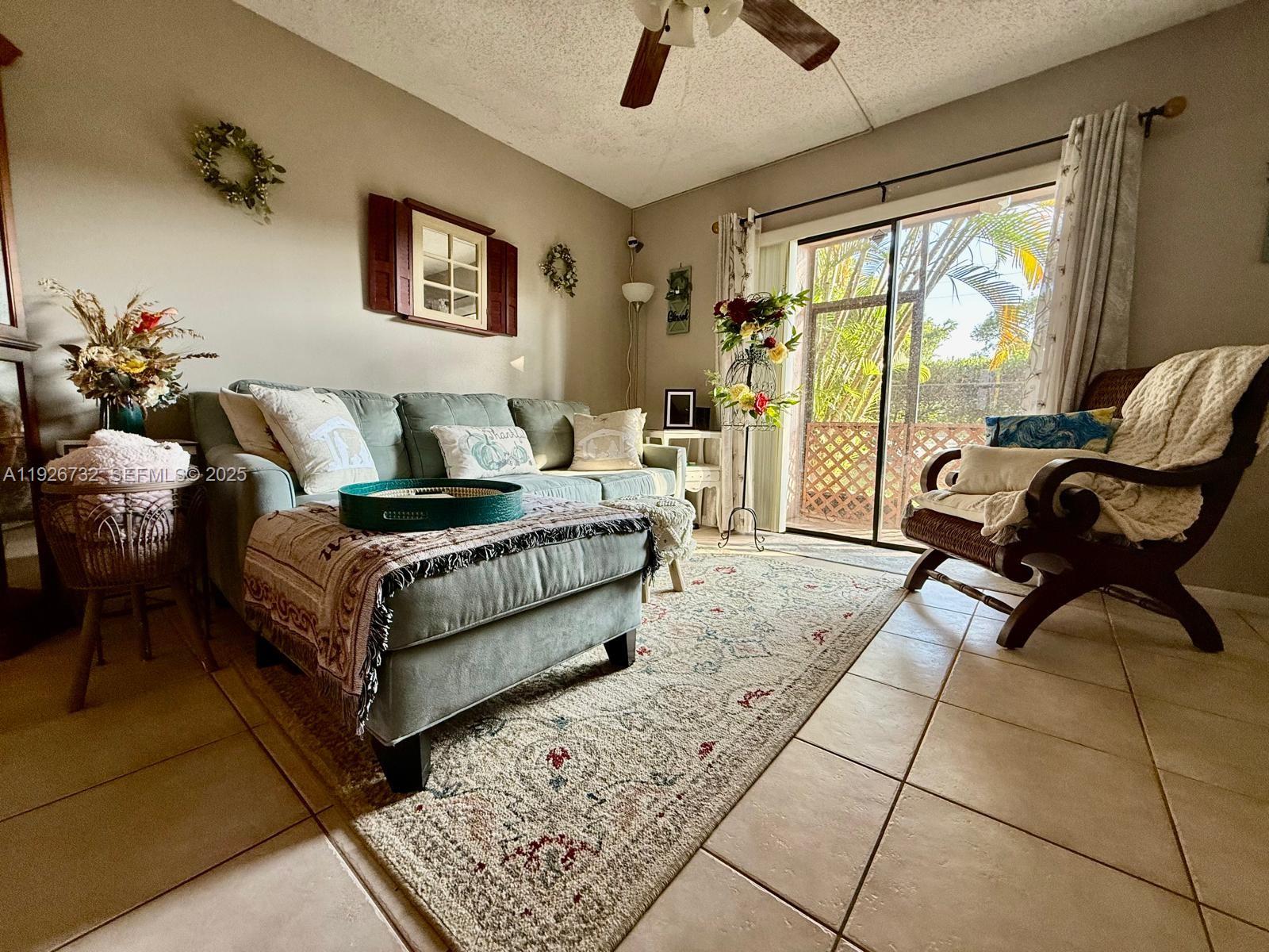 10616 Northwest 10th Street, Unit 104 Pembroke Pines, FL 33026 - Photo 8 of 47 a living room with furniture and a large window