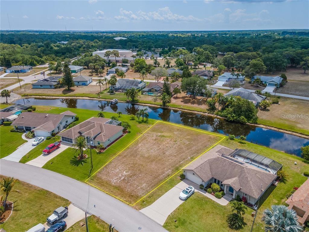 129 Bunker Road Rotonda West, FL 33947 - Photo 8 of 8 an aerial view of a house with a swimming pool yard and outdoor seating