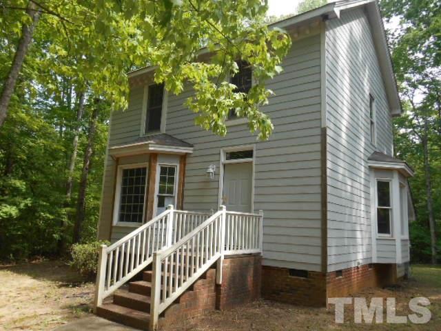 10821 Fanny Brown Road Raleigh, NC 27603 - Photo 1 of 9 a view of a house with a small yard and wooden fence