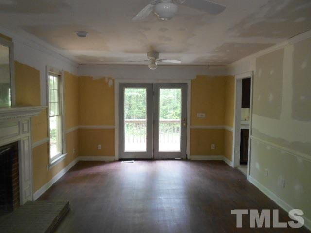 10821 Fanny Brown Road Raleigh, NC 27603 - Photo 5 of 9 an empty room with windows and fireplace