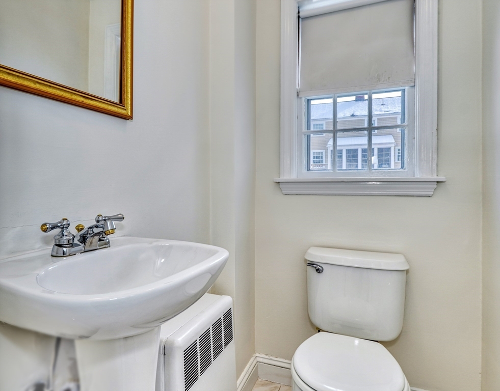 45 Bancroft Road Melrose, MA 02176 - Photo 14 of 37 a bathroom with a toilet a sink and mirror