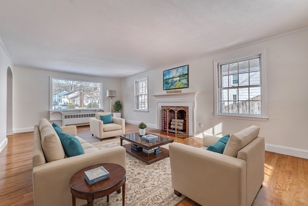 45 Bancroft Road Melrose, MA 02176 - Photo 4 of 37 a living room with furniture a fireplace and a large window