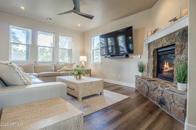 a view of a dining room with furniture a livingroom and chandelier