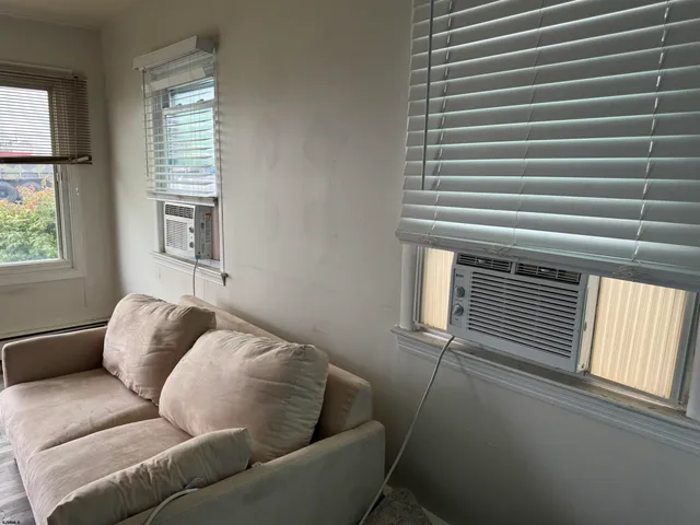 a kitchen with granite countertop white cabinets and stainless steel appliances