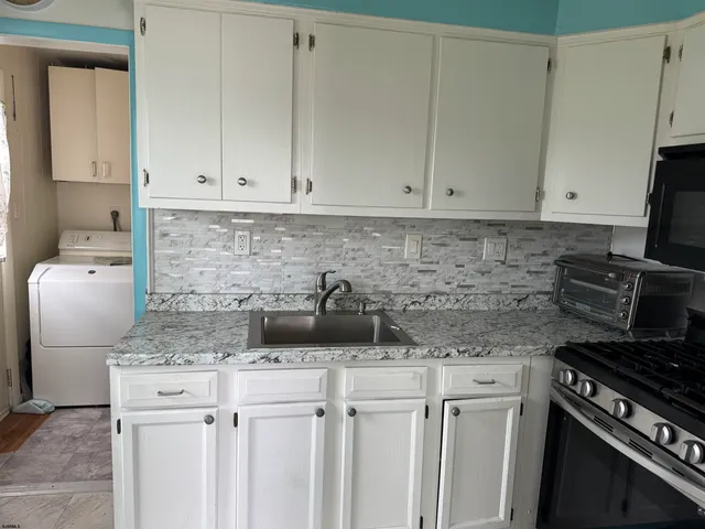 a kitchen with a sink and cabinets