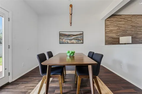 a view of a dining room with furniture wooden floor and a window