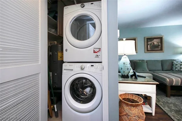 a living room with furniture and a washer dryer