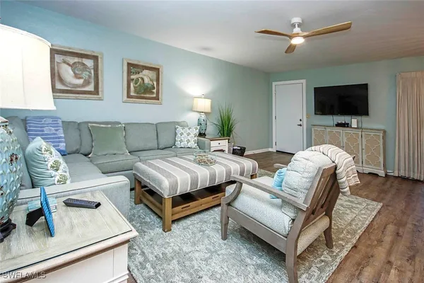 a living room with furniture and a flat screen tv