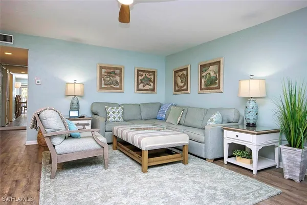 a living room with furniture and a lamp