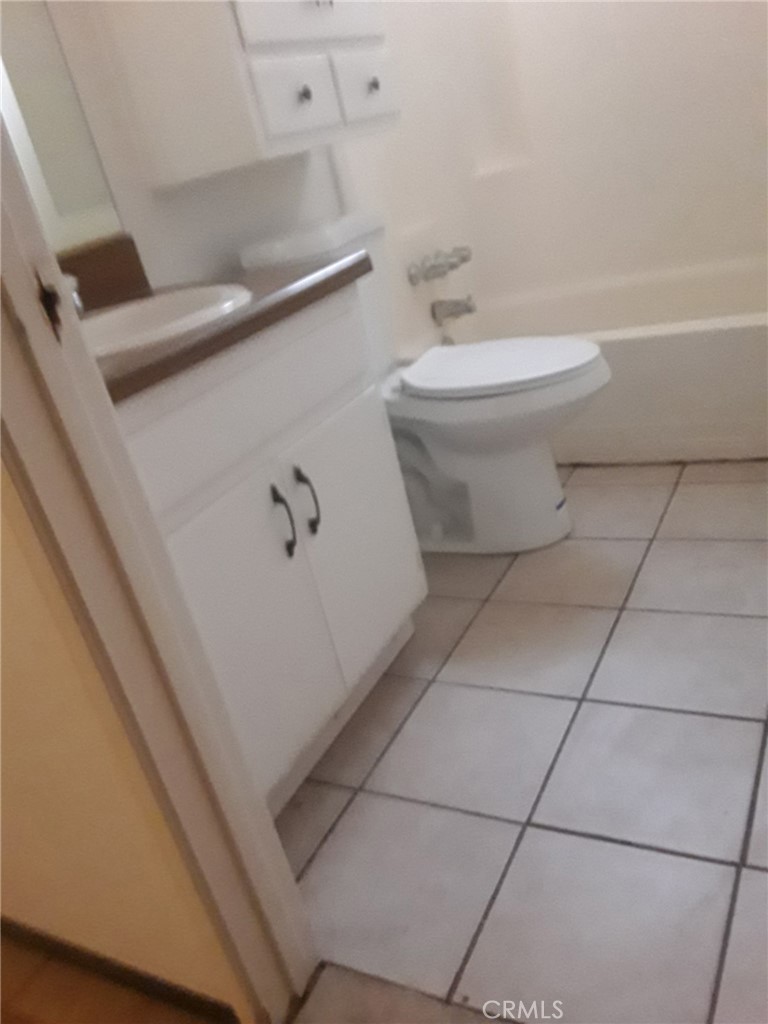 2248 North Arrowhead Avenue Rialto, CA 92377 - Photo 11 of 13 a bathroom with a toilet and a tub