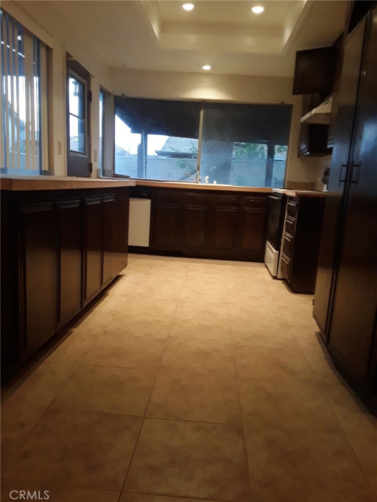 2248 North Arrowhead Avenue Rialto, CA 92377 - Photo 4 of 13 a large kitchen with stainless steel appliances a sink and a stove