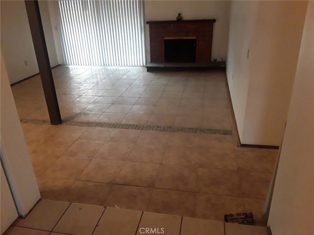 2248 North Arrowhead Avenue Rialto, CA 92377 - Photo 10 of 13 a view of an empty room with a fireplace