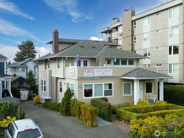 a front view of a residential apartment building with a yard