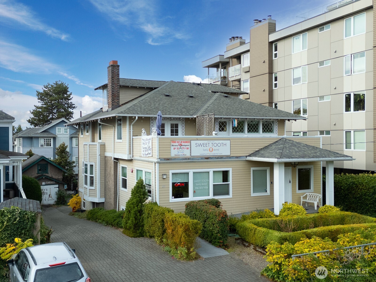 a front view of a residential apartment building with a yard