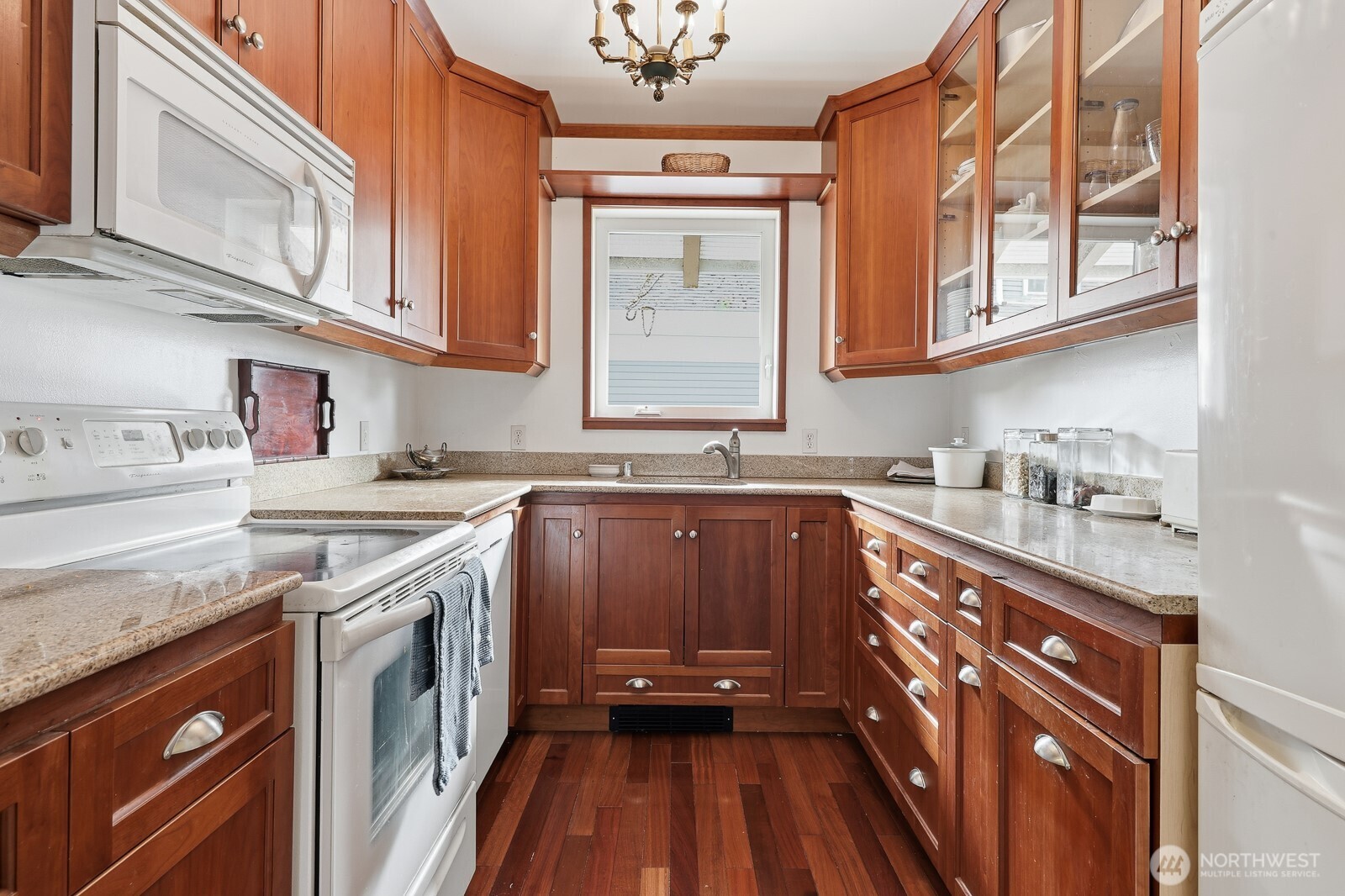 211 14th Avenue East Seattle, WA 98112 - Photo 11 of 32 a kitchen with stainless steel appliances granite countertop a sink stove and cabinets