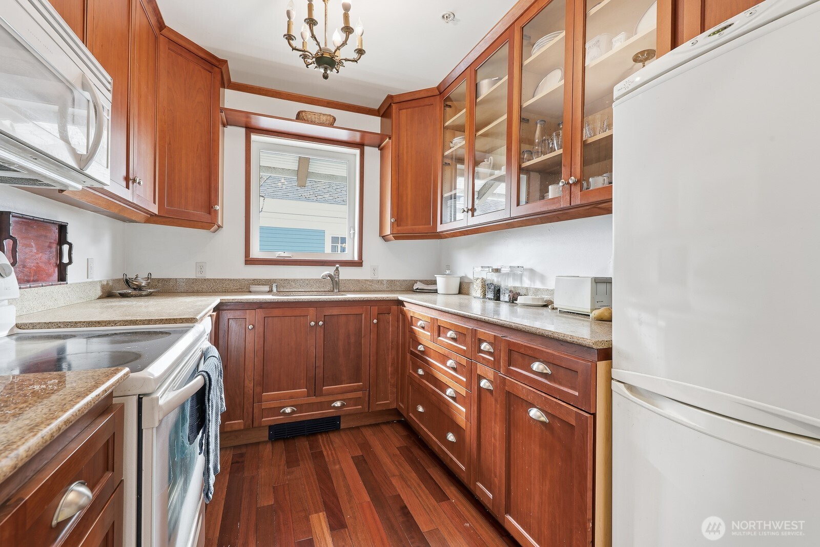 211 14th Avenue East Seattle, WA 98112 - Photo 12 of 32 a kitchen with granite countertop a sink and a stove