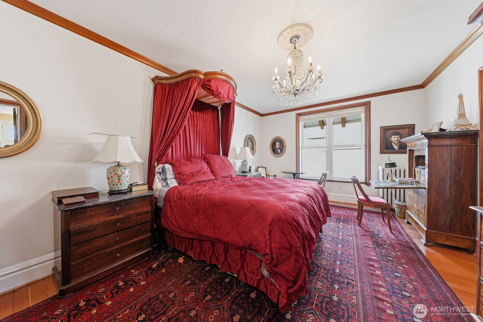 211 14th Avenue East Seattle, WA 98112 - Photo 13 of 32 a bedroom with a bed and a chandelier