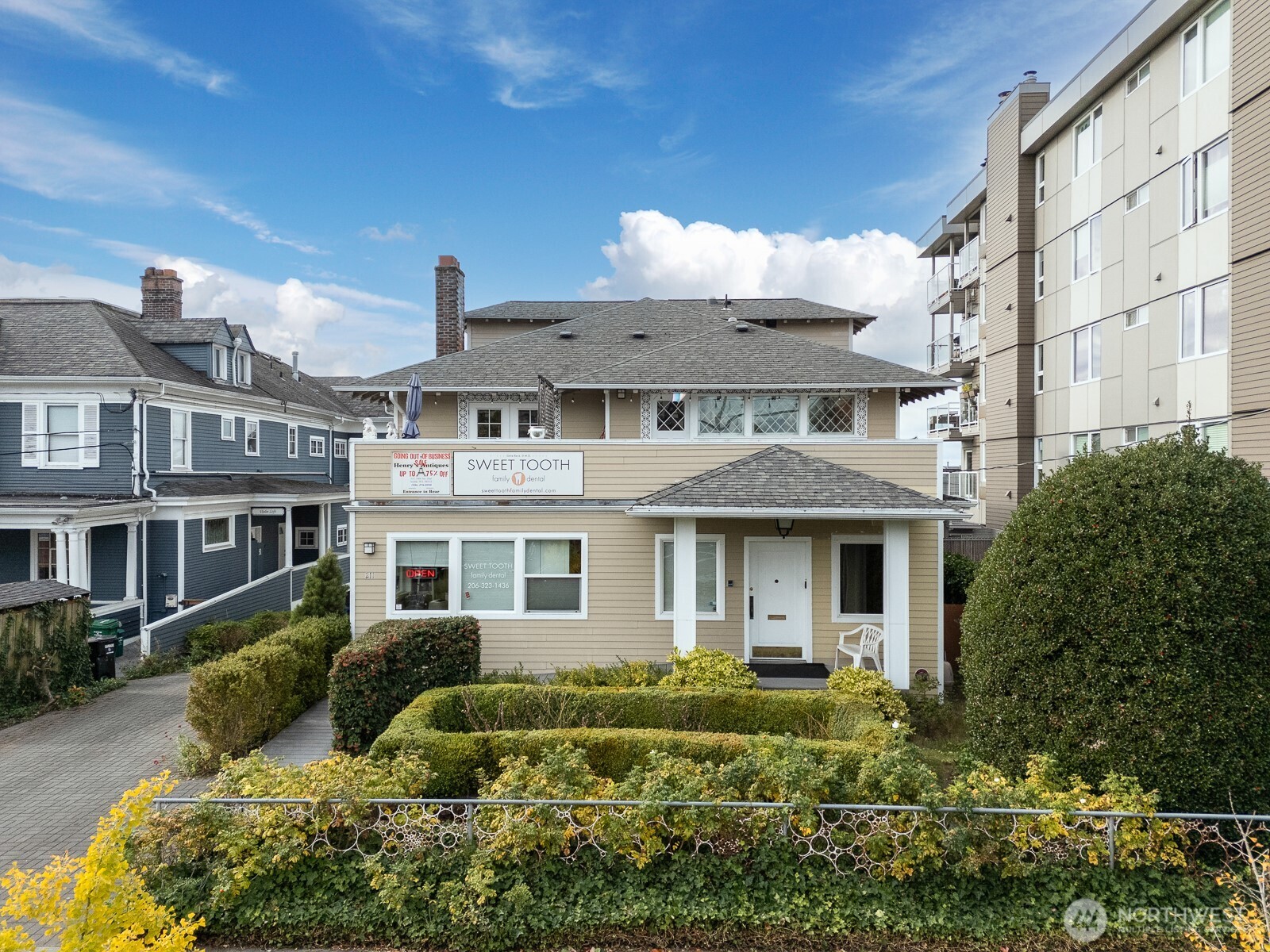211 14th Avenue East Seattle, WA 98112 - Photo 31 of 32 a front view of a residential apartment building with a yard