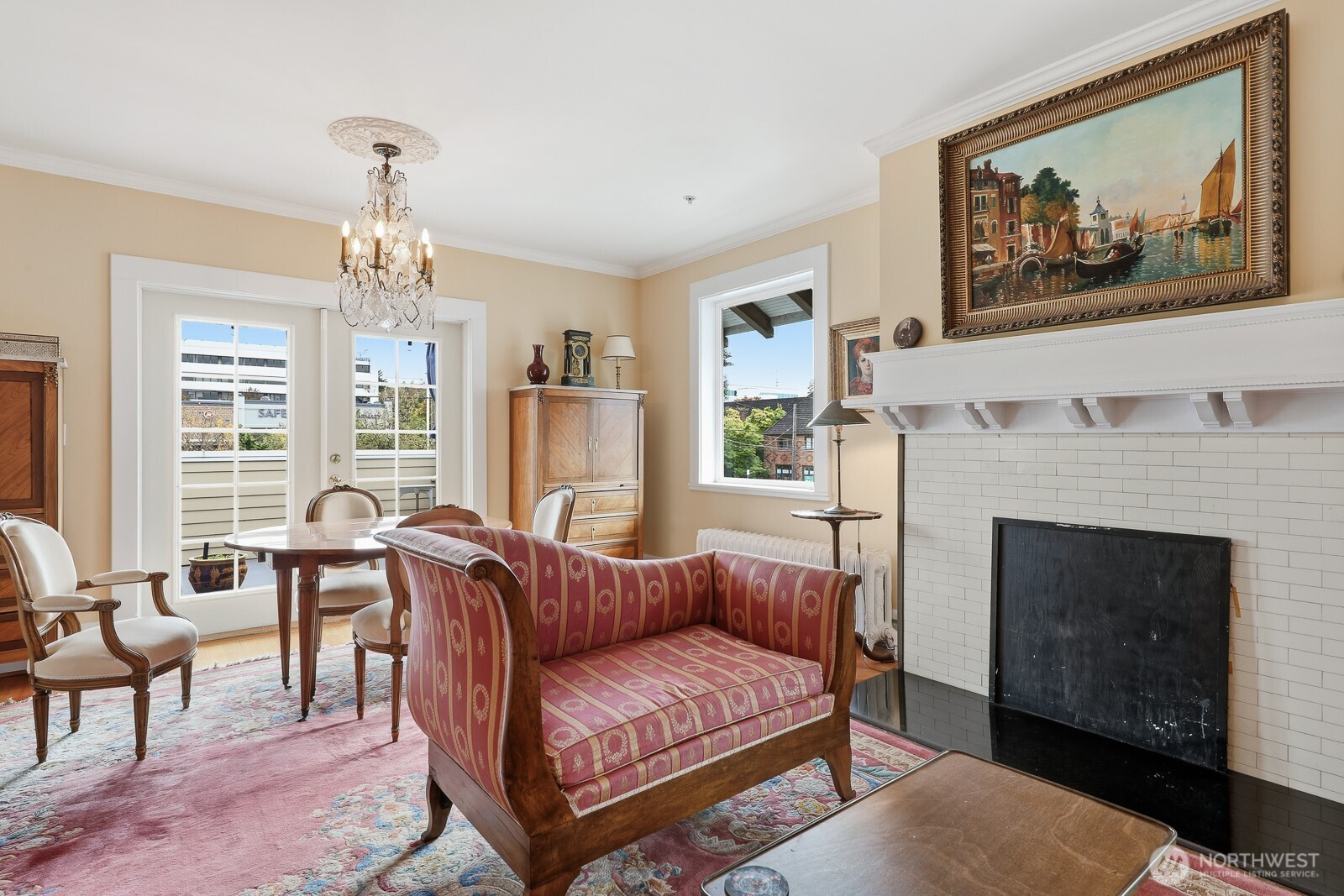 211 14th Avenue East Seattle, WA 98112 - Photo 7 of 32 a living room with furniture a fireplace and a large mirror