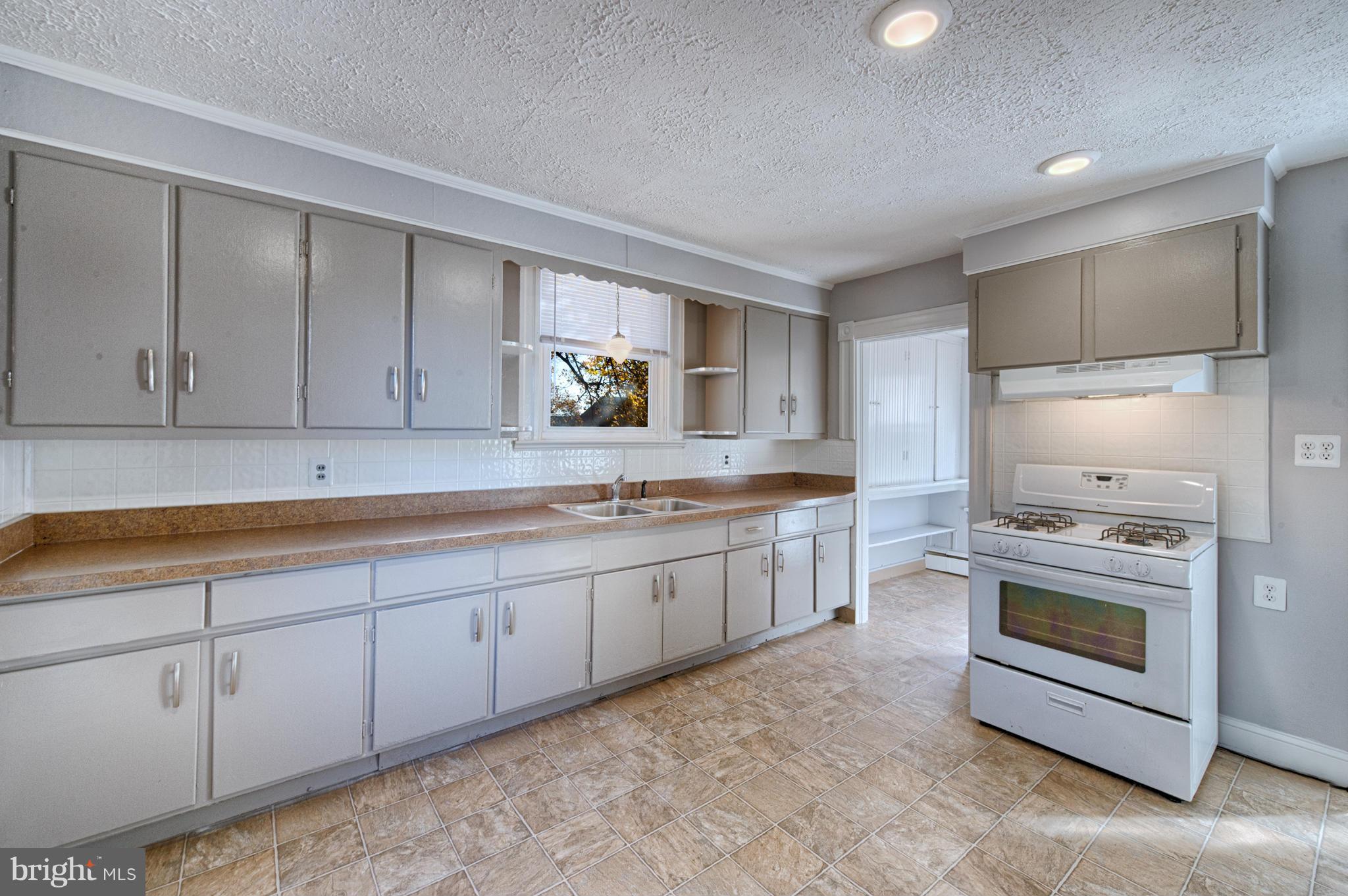 2415 Rocks Road Forest Hill, MD 21050 - Photo 26 of 30 a kitchen with granite countertop white cabinets white stainless steel appliances with a sink and dishwasher
