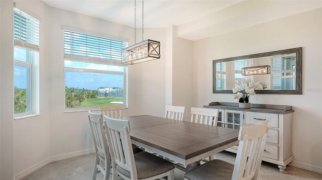 12180 Wellen Golf Street, Unit 202 Venice, FL 34293 - Photo 16 of 88 a view of a dining room with furniture window and outside view