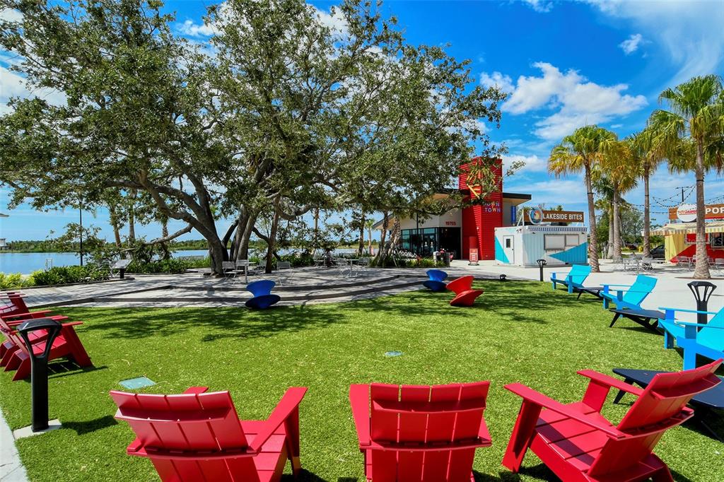 12180 Wellen Golf Street, Unit 202 Venice, FL 34293 - Photo 74 of 88 a view of a swimming pool and lounge chairs in back yard