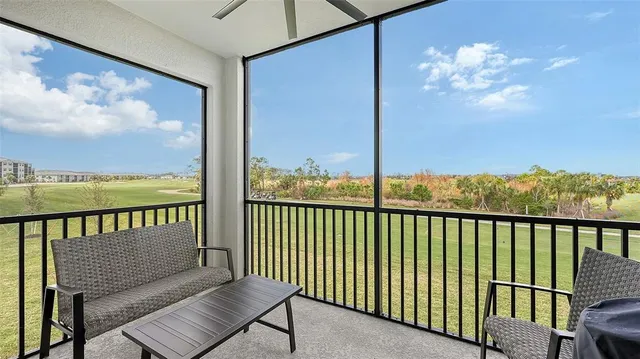 a living room with furniture and a view of kitchen