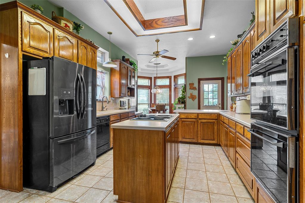 654 County Road 473 Lott, TX 76656 - Photo 11 of 40 a kitchen with stainless steel appliances granite countertop a refrigerator and a stove