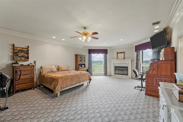 a spacious bedroom with a bed and a fireplace