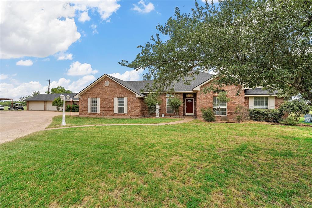 654 County Road 473 Lott, TX 76656 - Photo 2 of 40 a front view of a house with a yard and trees