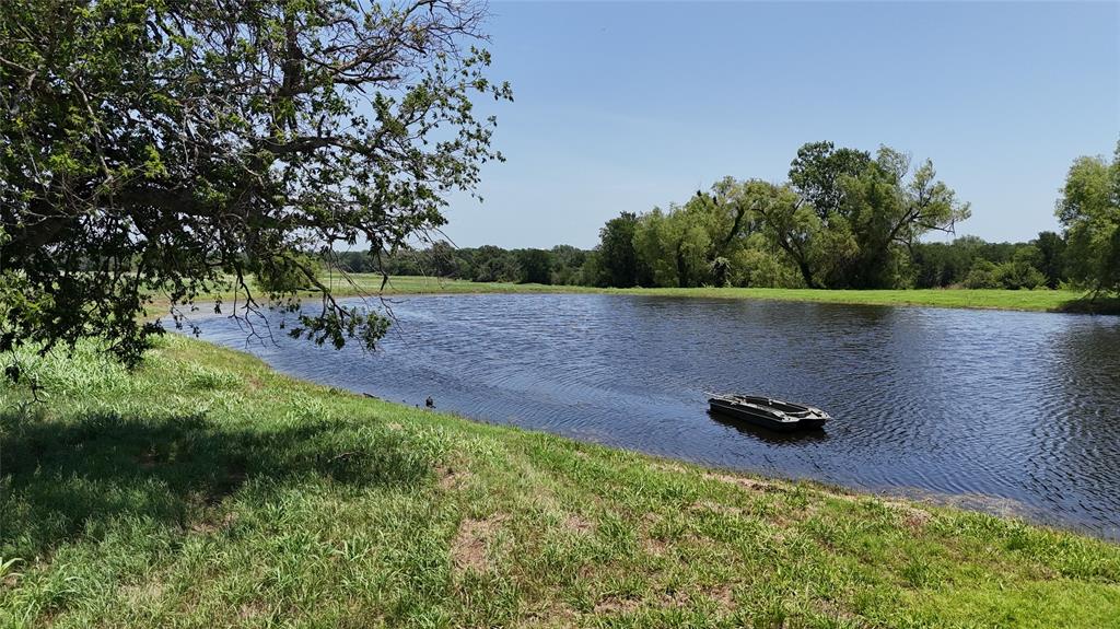 654 County Road 473 Lott, TX 76656 - Photo 26 of 40 a view of a backyard of a house with lots of green space and trees