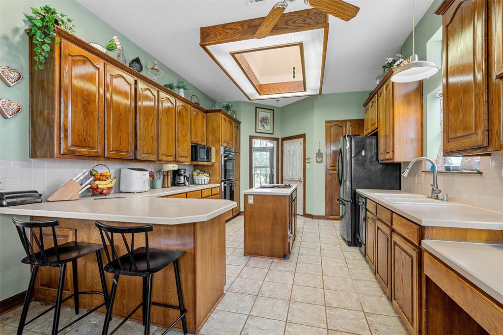 654 County Road 473 Lott, TX 76656 - Photo 10 of 40 a kitchen with stainless steel appliances granite countertop a sink and cabinets