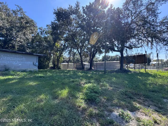 a view of outdoor space with deck and yard