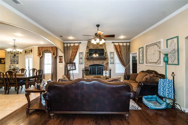 a living room with furniture a fireplace and large windows