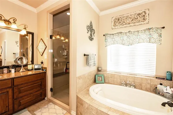 a bathroom with a tub sink and mirror