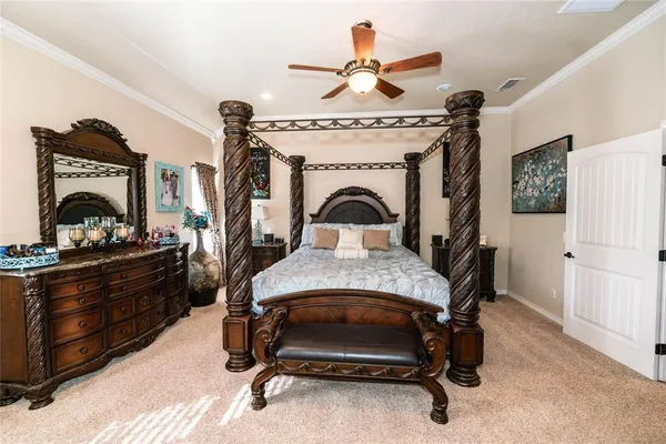 a bedroom with a bed a flat screen tv and dresser