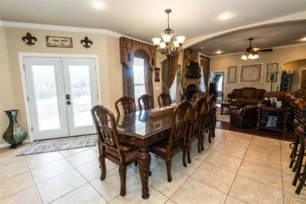 a living room with furniture ceiling fan and a flat screen tv