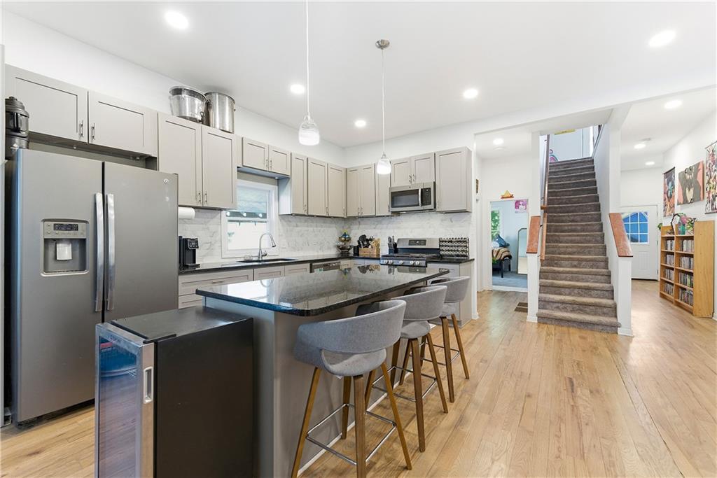 902 Gaston Street Southwest Atlanta, GA 30310 - Photo 13 of 36 a kitchen with stainless steel appliances granite countertop a refrigerator a sink and a stove