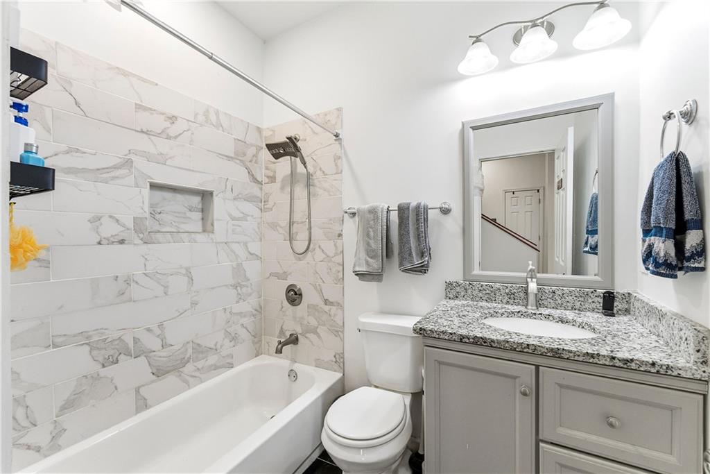 902 Gaston Street Southwest Atlanta, GA 30310 - Photo 15 of 36 a bathroom with a granite countertop sink toilet and shower